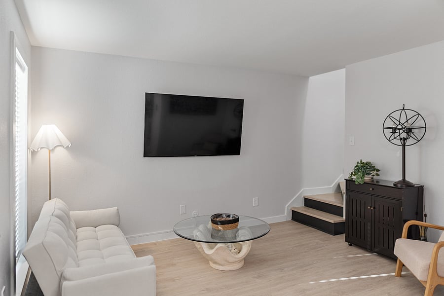 Welcome inside! Step through the door & into our living room. It comes with new furniture, Smart Tv, & futon couch.