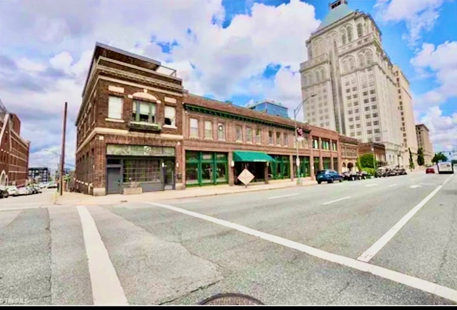 This 1920s historic building was originally at grocery store so it's really cool with the high ceilings and the monstrous storefront windows. Who needs TV when you can look right out of your window.