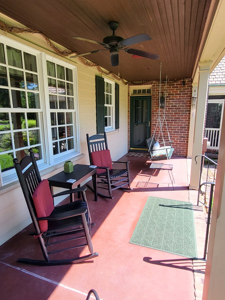Side porch with rockers and swing bench where you can unwind and/or enjoy your favorite beverage.