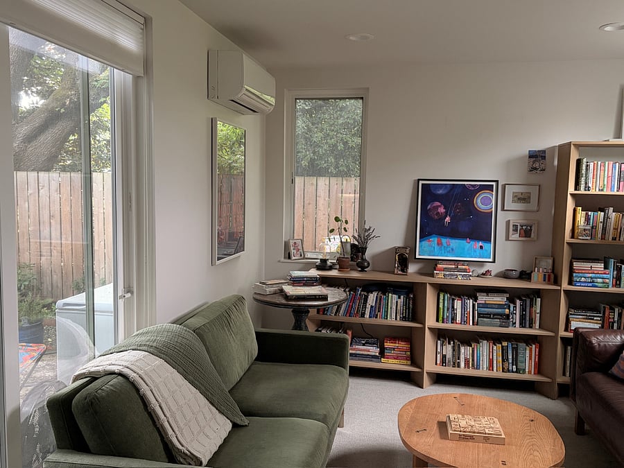 Living room with sliding glass door that opens up onto the backyard