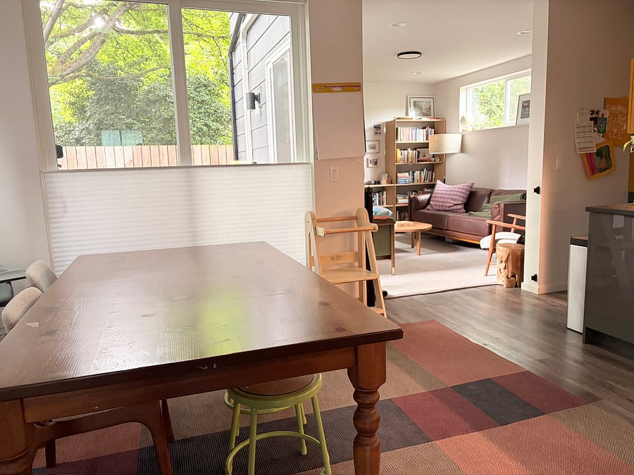 Small dining and work area next to kitchen. Sliding glass doors open up onto patio and garden.