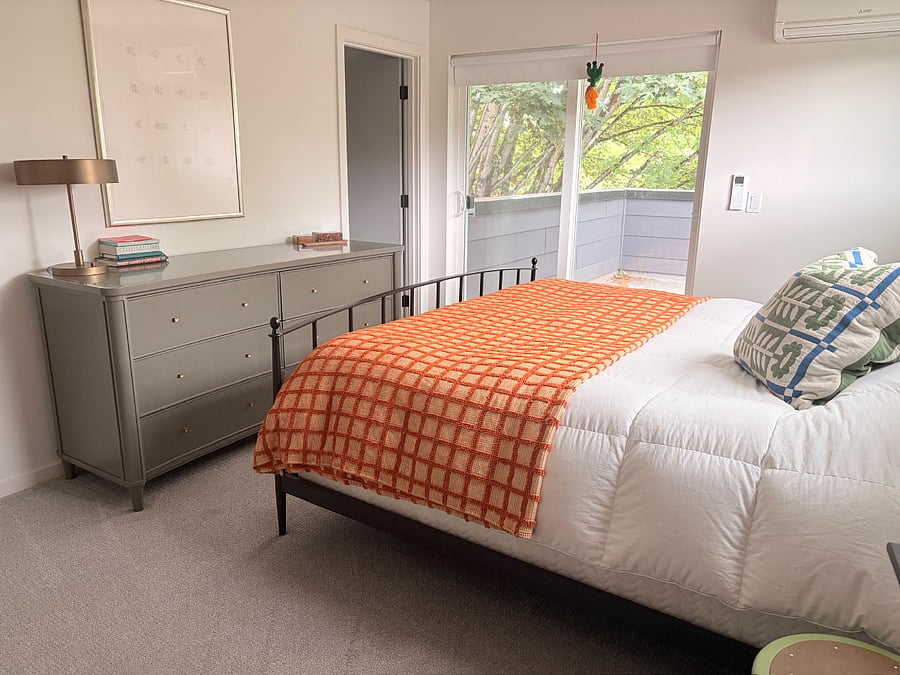 Primary bedroom on the top floor has an ensuite bathroom with rain shower, walk in closet, and private terrace under the trees