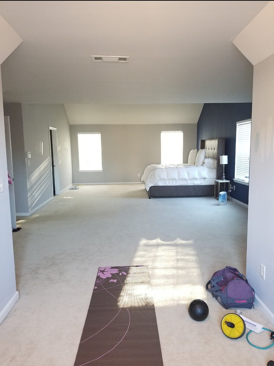 Expansive 800 Sq Ft Primary Suite featuring a king bed, private lounge area, dedicated workout space