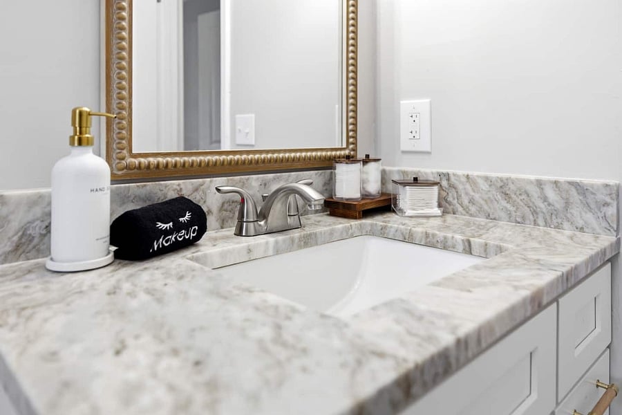 Elegant marble vanity with stylish finishes and plenty of counter space.