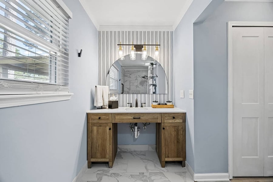 The primary bathroom is designed with all guests in mind, featuring an extra-wide entrance and a wheelchair-accessible vanity.  This space comes fully stocked with fresh towels, cotton swabs, and a hairdryer, so guests have everything they need.