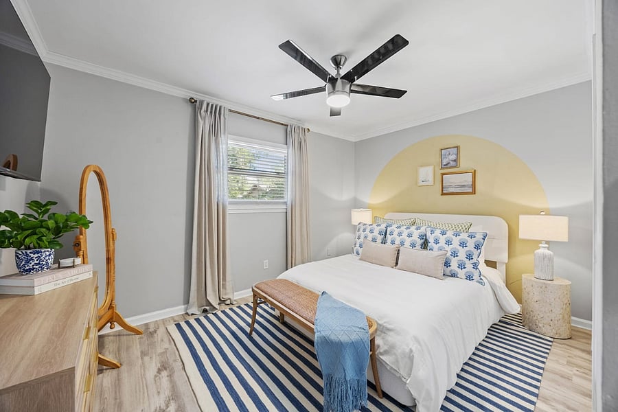 This inviting queen bedroom offers a peaceful retreat with comfortable bedding, stylish decor, and a calming atmosphere for a restful night's sleep.