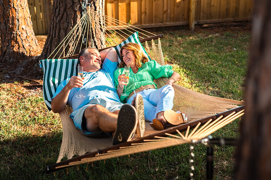 This cozy hammock zone sits in the shade of the backyard trees, offering a quiet place to relax inside the secure, fenced-in yard.