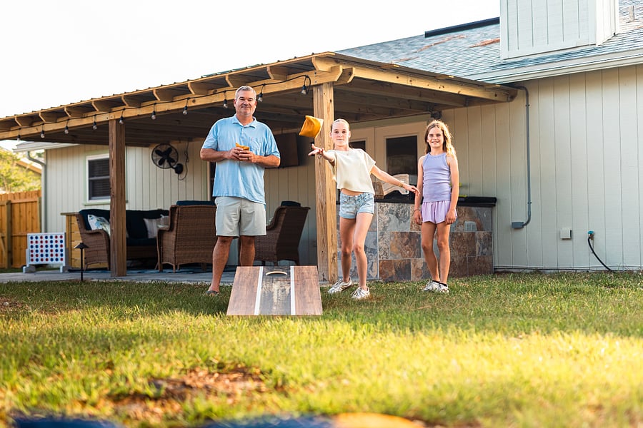 The large backyard is perfect for gathering, playing yard games, or simply unwinding in the fresh air.
