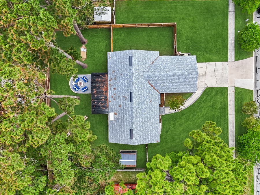 This aerial view showcases the spacious fenced-in backyard along with a gated side yard, perfect for boat or RV storage.