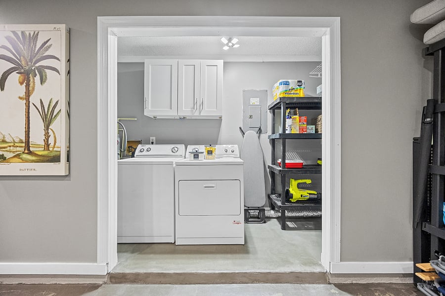 Dedicated laundry area, complete with laundry detergent, dryer sheets, iron, steamer, and drying rack, all available for guest use.