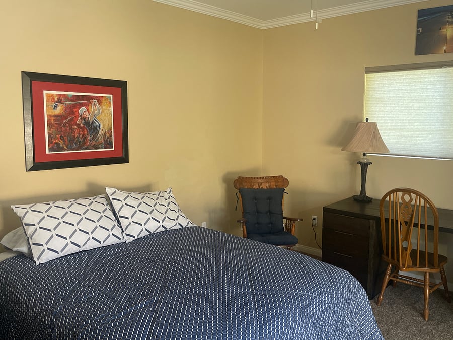 Bed room has a  dedicated work space with a desk, three hole punch, scissors, stapler, pens, pencils, note paper etc. 