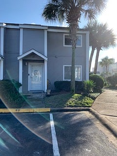Front of condo with parking space directly in front of door