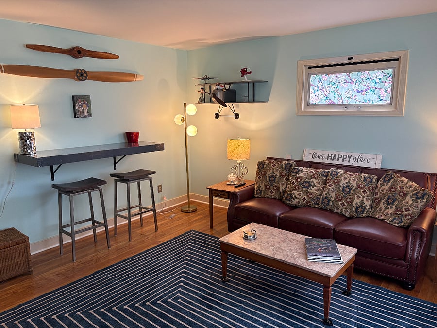 Comfy sofa and recliner (not shown) with high bar and stools. 