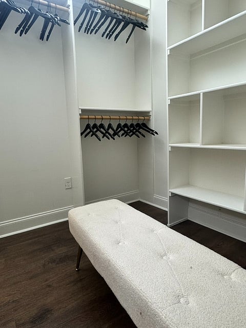 Walk In Closet. Ample wooden hangers. Sitting bench. Floor mirror. Ironing board, with iron and a steamer. Extra set of sheets.