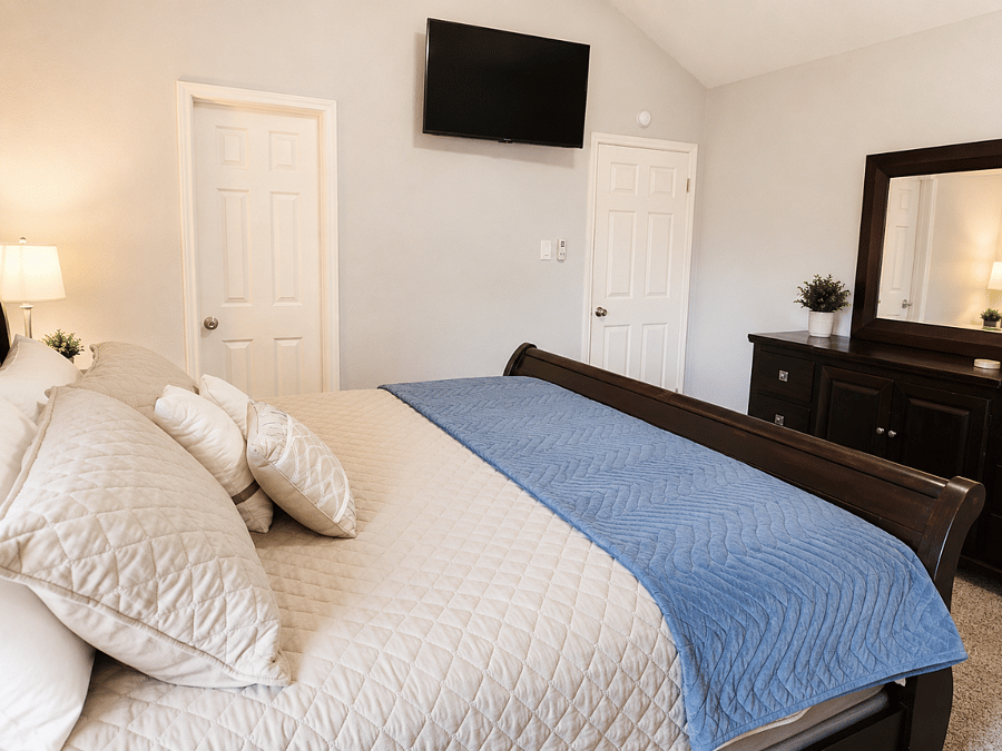 Primary bedroom with king bed, dressers, nightstands, TV and en suite bathroom and closet.