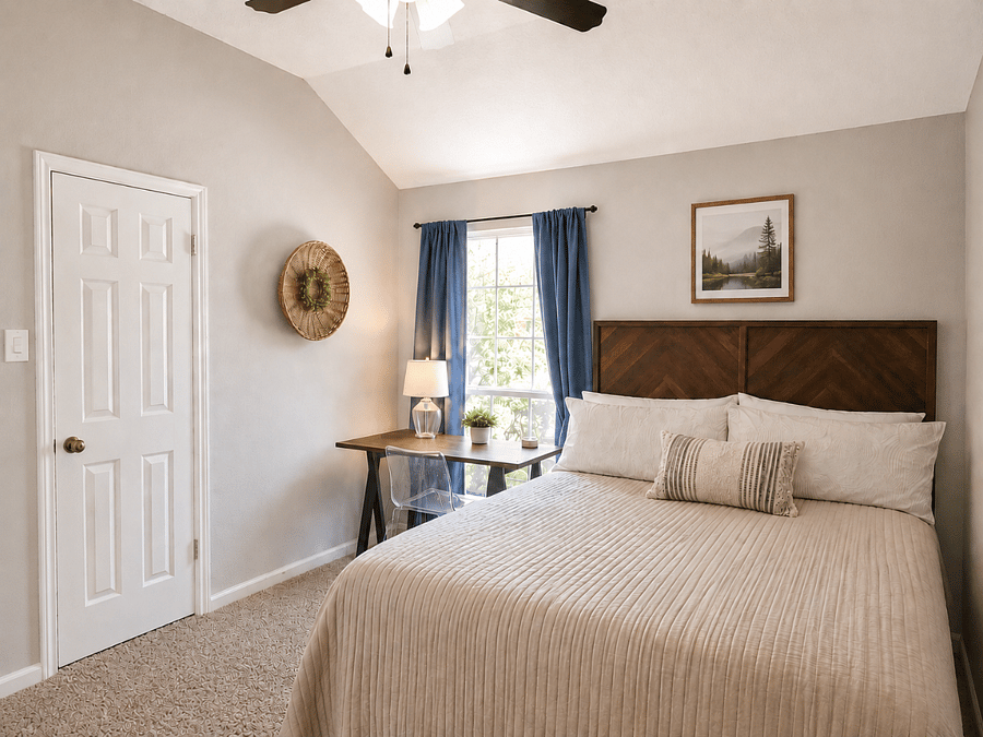Queen bedroom with desk with window view, chair, dresser and closet.