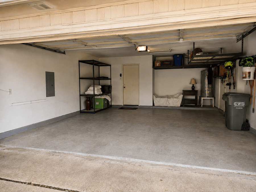 Two car garage with storage and covered driveway additional parking.