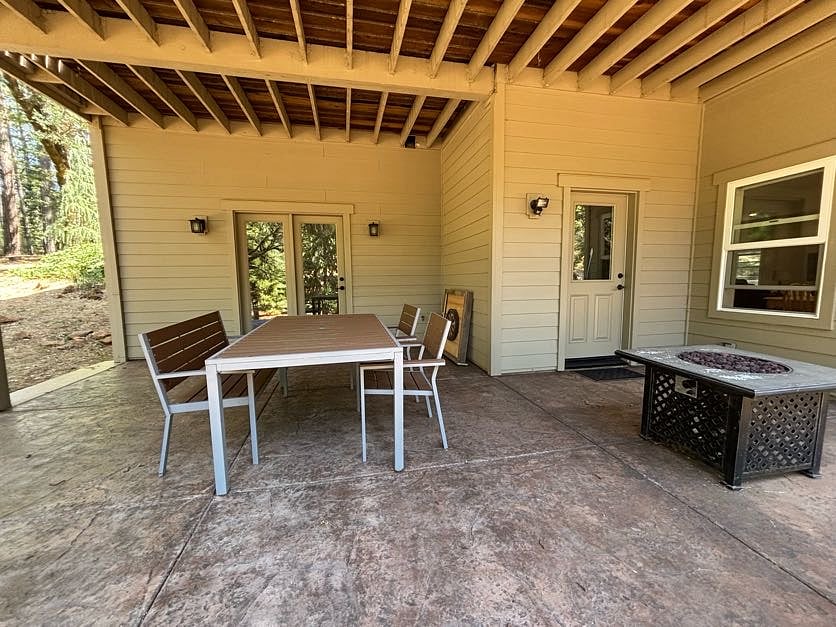 Patio area with table and fire pit. 