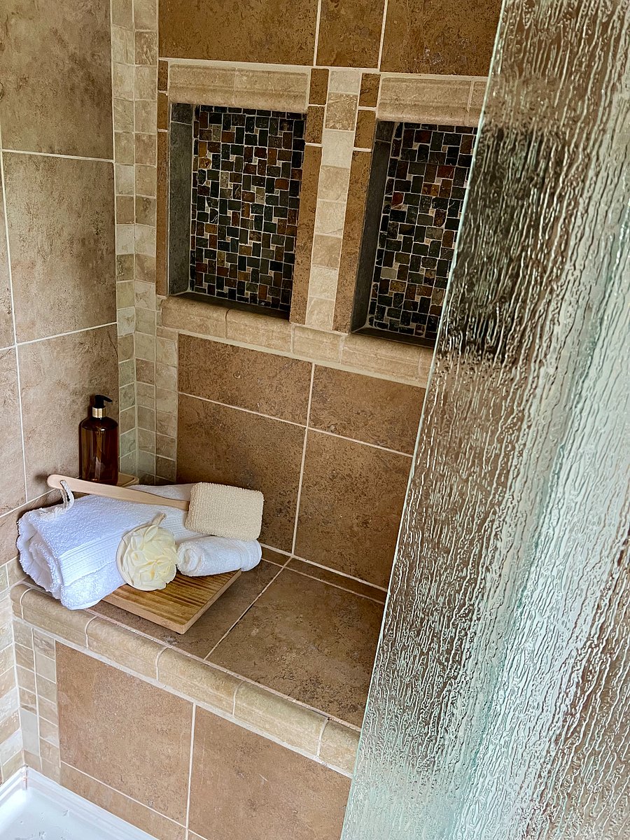 Main-level walk-in shower with seat for spa-like steam bathing
