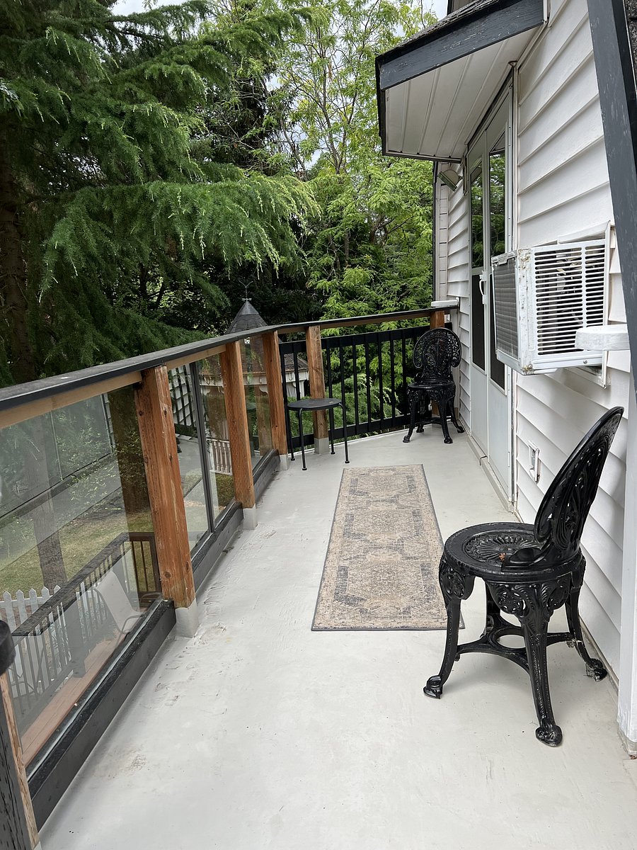 Balcony off the upstairs bedroom has stairway down to lower deck and yard. Perfect balcony for birdwatching and morning coffee.