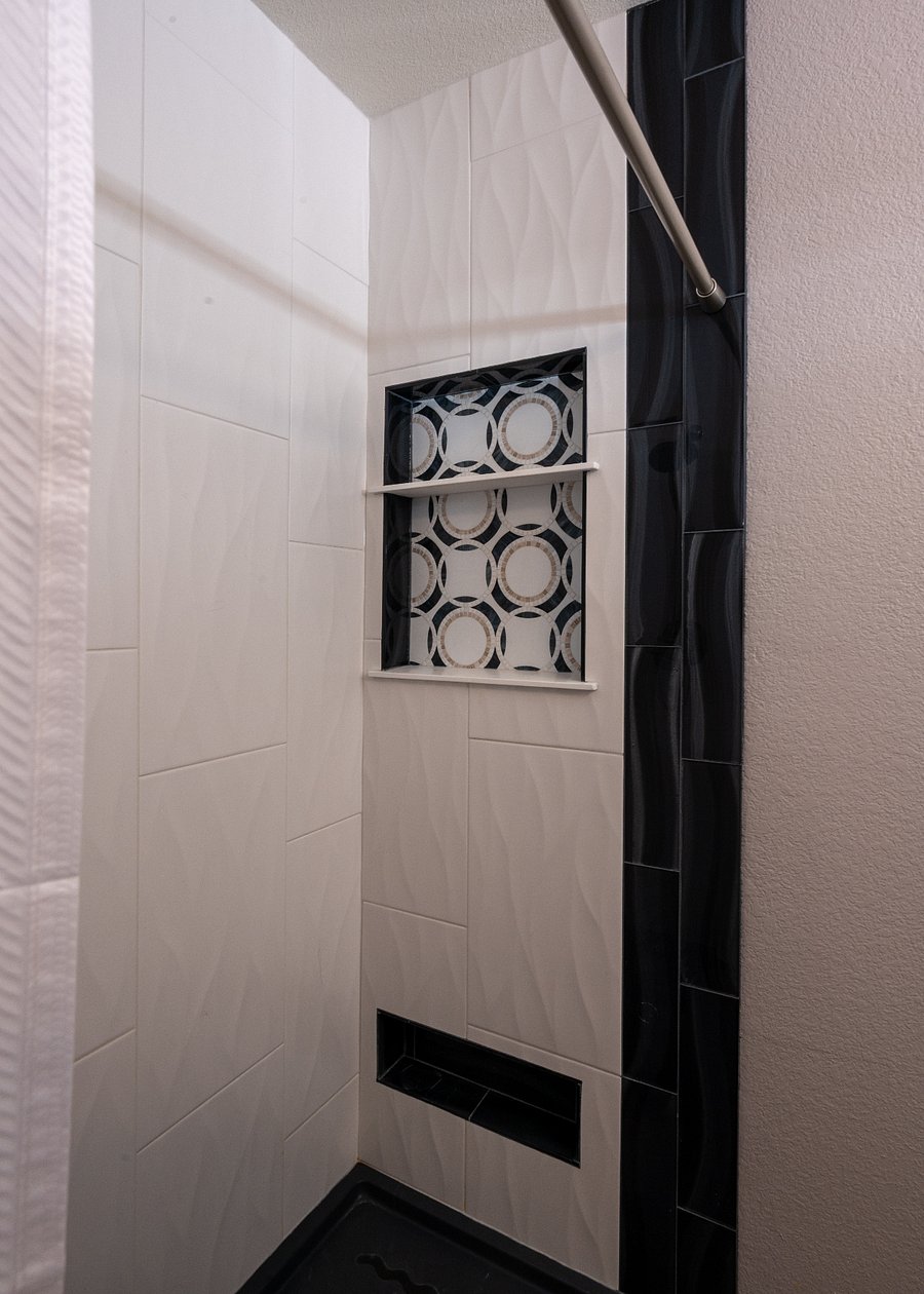 Primary ensuite bathroom. Newly remodeled walk in shower with custom tile and uses a curtain (no doors to clean)