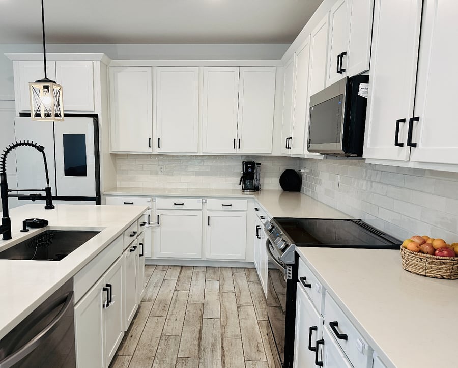 A chef's dream kitchen featuring a bespoke Samsung fridge, premium stainless steel appliances, black hardware, and a built-in RO system serving up the absolute best water ever.