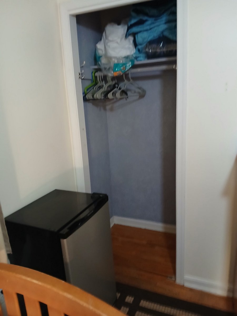 Furnished bedroom: closet and refrigerator