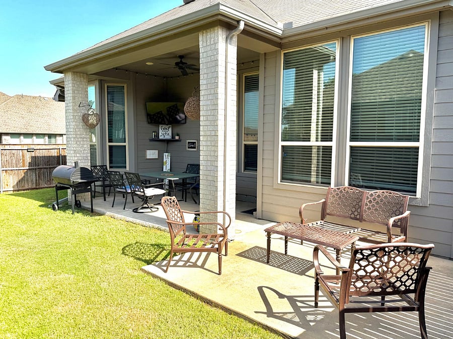 Out here, time softens. You can gather under the covered patio, settle into comfortable outdoor seating, and let the television play softly in the background while the grill warms the air.