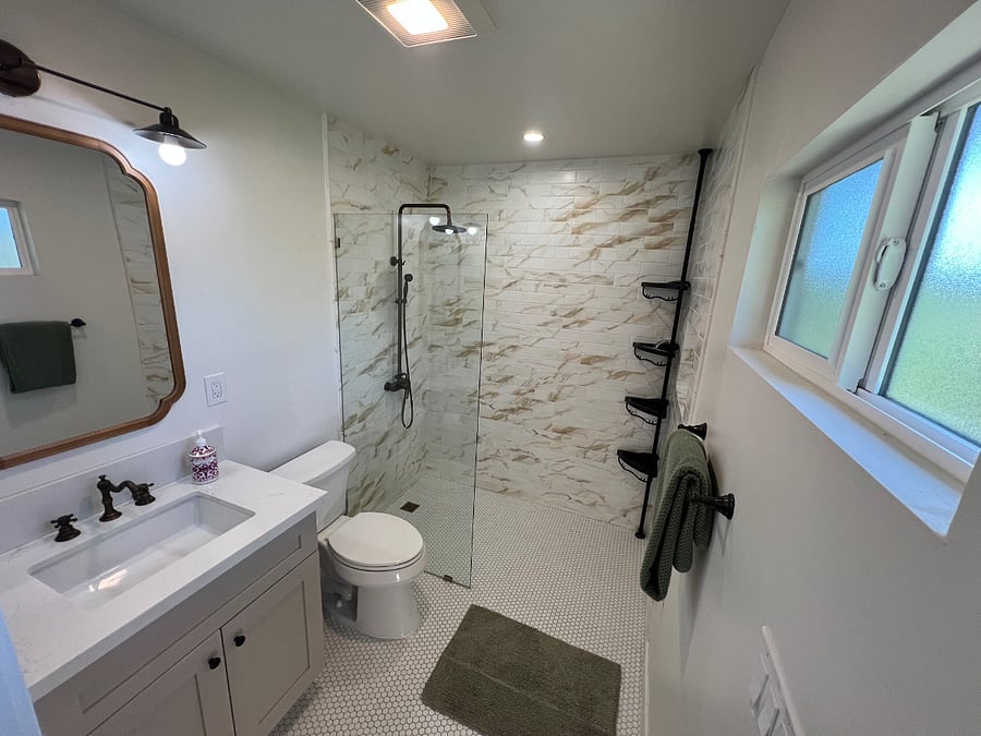 Primary bath with rain shower and separate body shower nozzle.