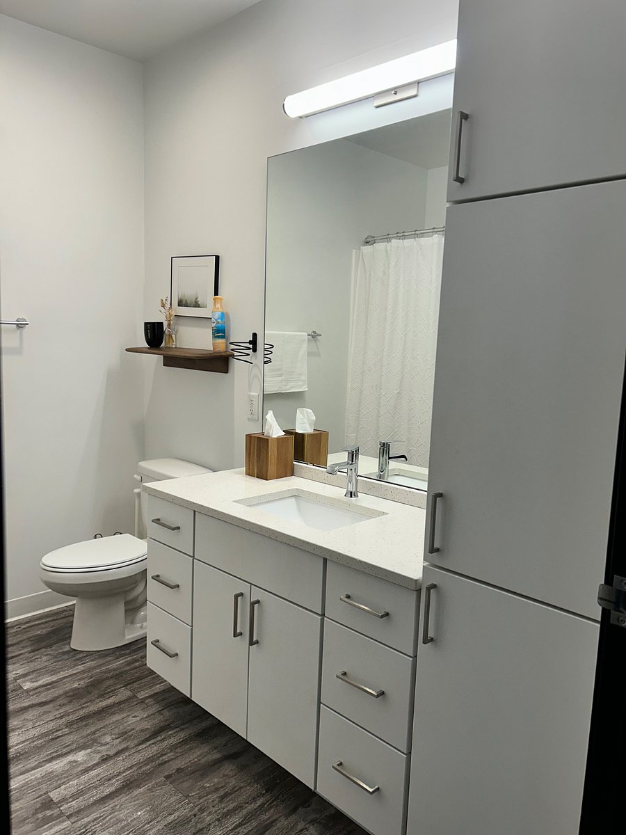 Clean, modern bathroom with quartz vanity and walk-in shower.