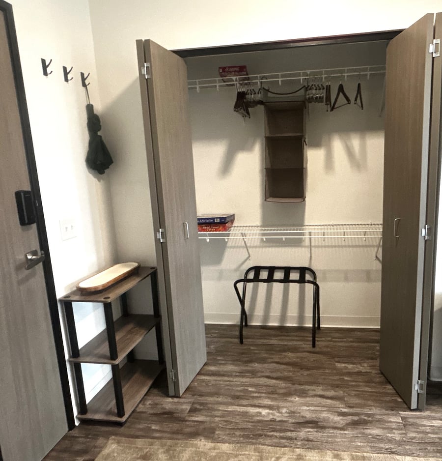 Spacious walk-in closet with hanging storage ideal for extended stays.