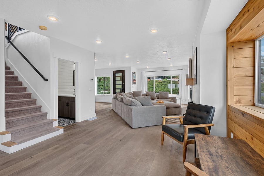 View from sitting area of living room, half bath, and stairs to upper level