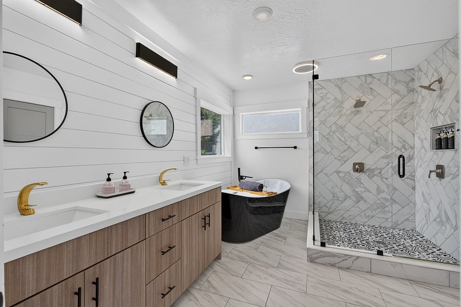 Master bathroom view of standalone bathtub and community shower