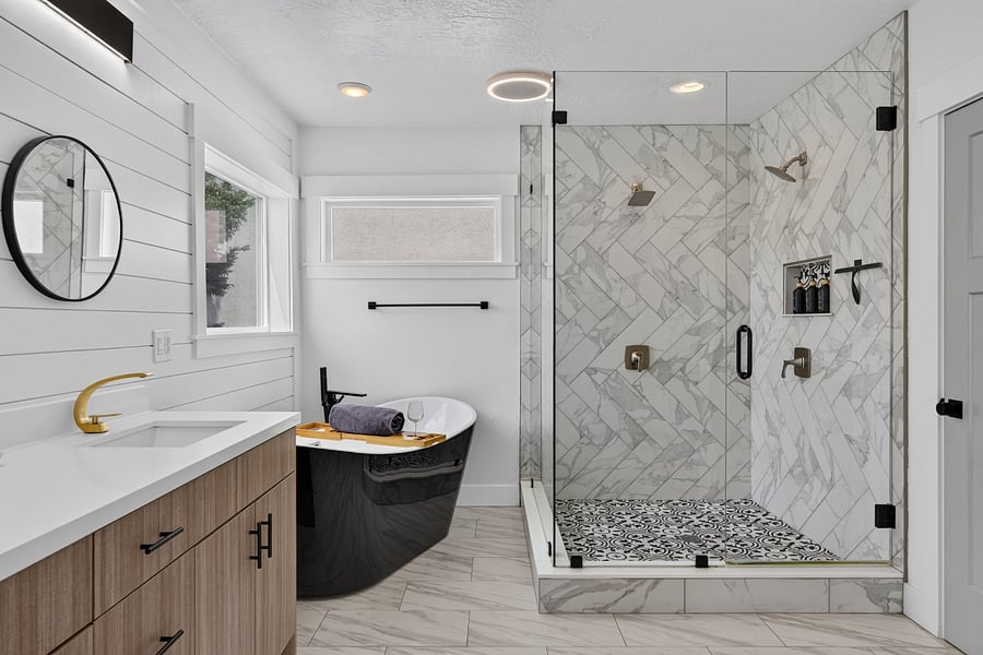 Master bathroom view of standalone bathtub and community shower