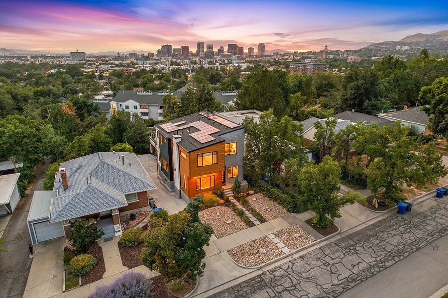 Drone view of the house with the SLC skyline and Oquirrh mountains in the background