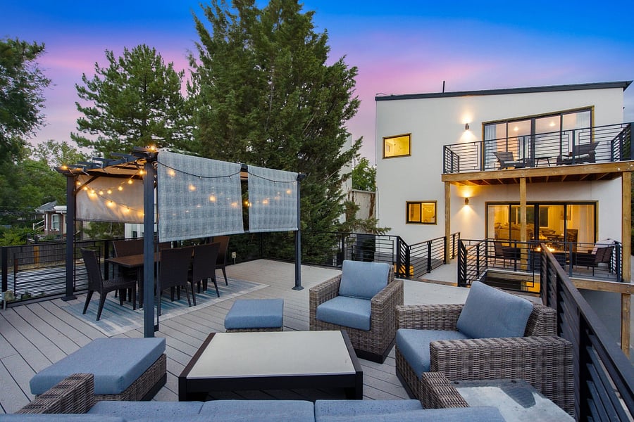 Back deck showing seating area, dining area, and rear view of the house