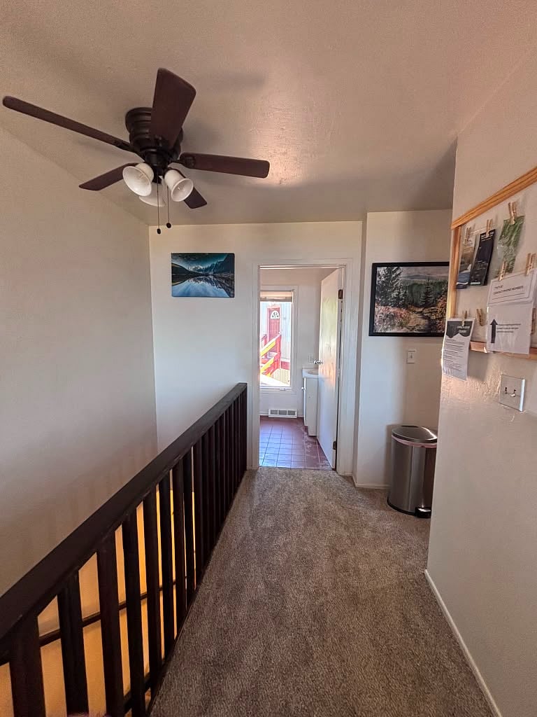 Top of stairs looking towards half bathroom and kitchen