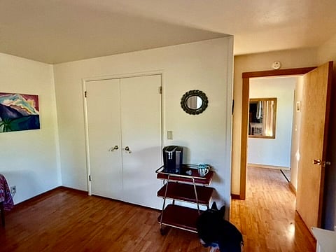 Closet doors, with Keurig. On the right is the foyer with large mirror.