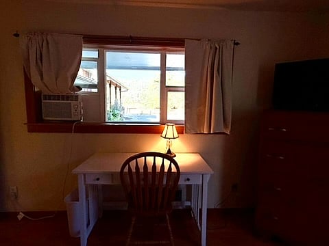 Computer desk, table with chair facing east toward Mt. Pisgah. Blackout curtains.