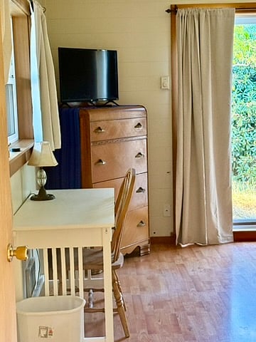 Computer table, bureau and Roku TV.