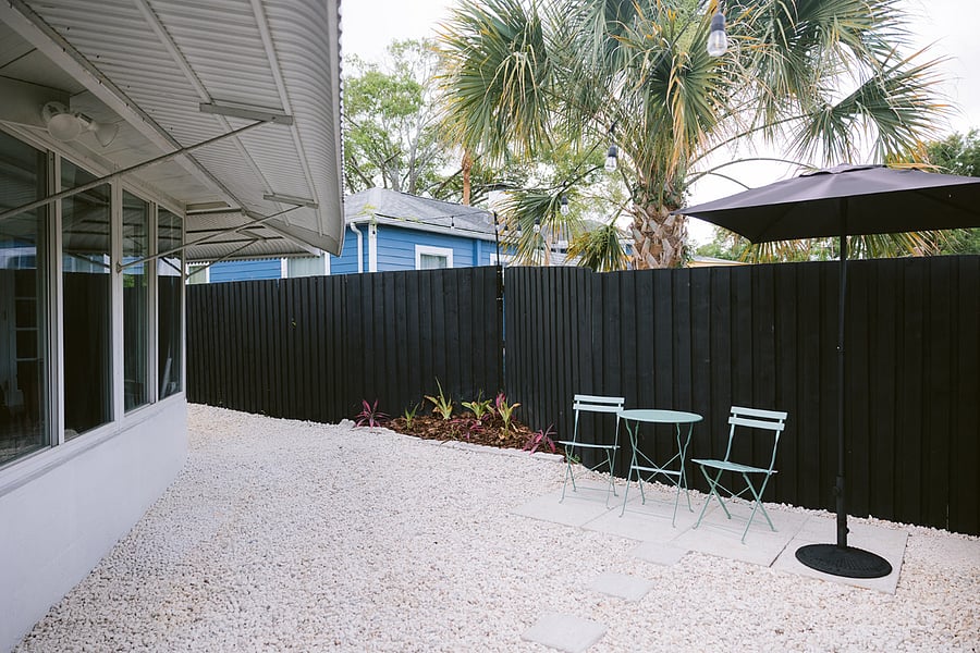 PATIO IN BACKYARD WITH SITTING AREA & UMBRELLA