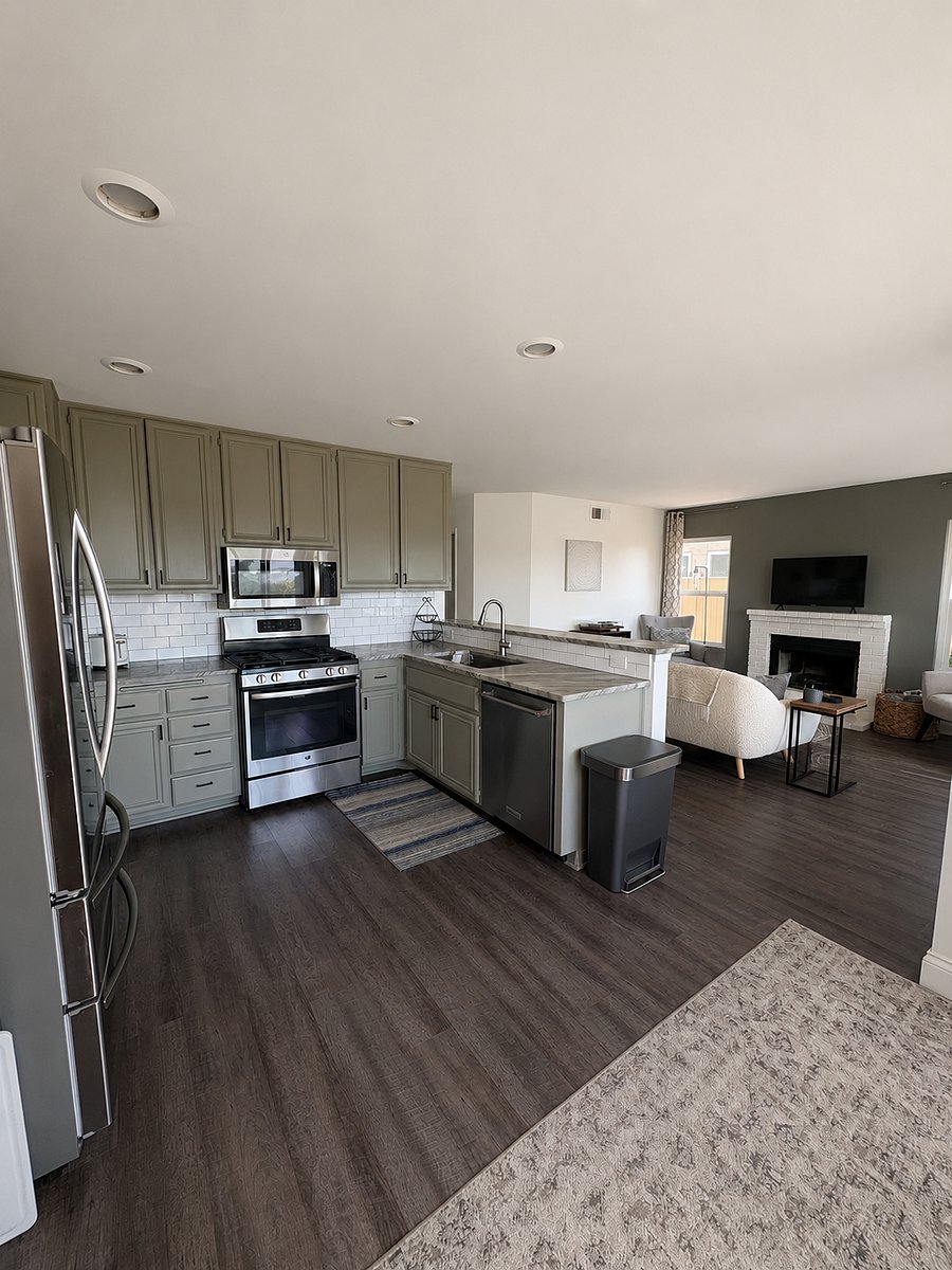 Kitchen overlooking sitting room. GE oven and stovetop. 