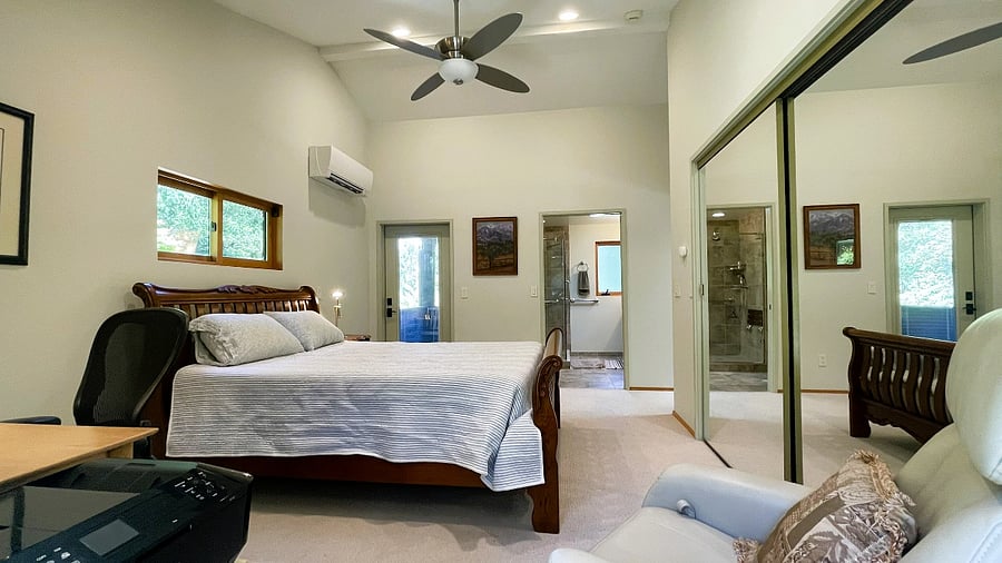 bedroom from opposite wall, looking across to bathroom door and back porch door