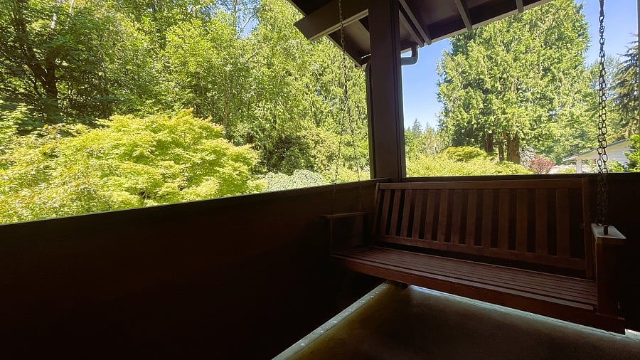 private back porch with porch swing