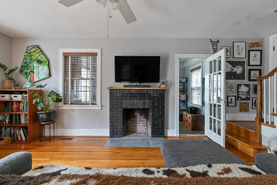 The living room features a large smart tv, expandable couch perfect for snuggling up and napping, as well as a Crosley record player/bluetooth speaker. The bookshelves are lined with enough titles to occupy the most voracious reader.
