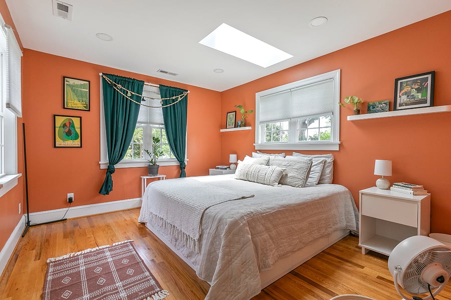 All three bedrooms are upstairs, in an ideal configuration for single travelers, parents with kids, or friends sharing the house. One bedroom is drenched in natural light from windows across three walls, in addition to the skylight that allows you to sleep under the stars in the luxurious comfort of a California king bed with designer linens. Bedside tables (on both sides) with matching lamps and plenty of outlets means everyone gets to enjoy bedtime at their own pace. This room features a large walk-in closet.