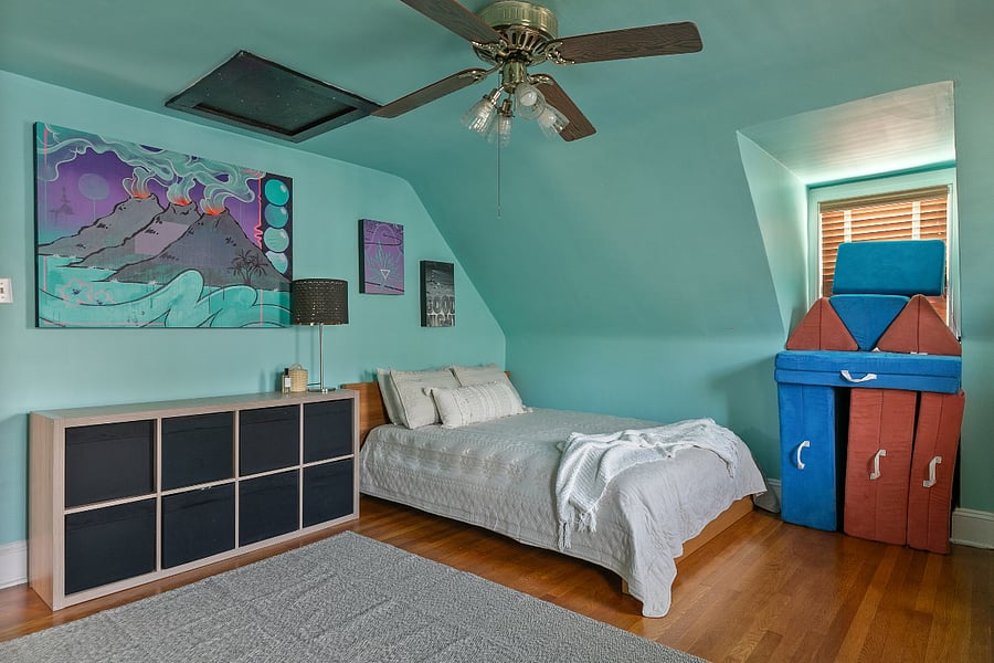 This bedroom/office features a queen bed and plenty of closet space with charming dormer windows.