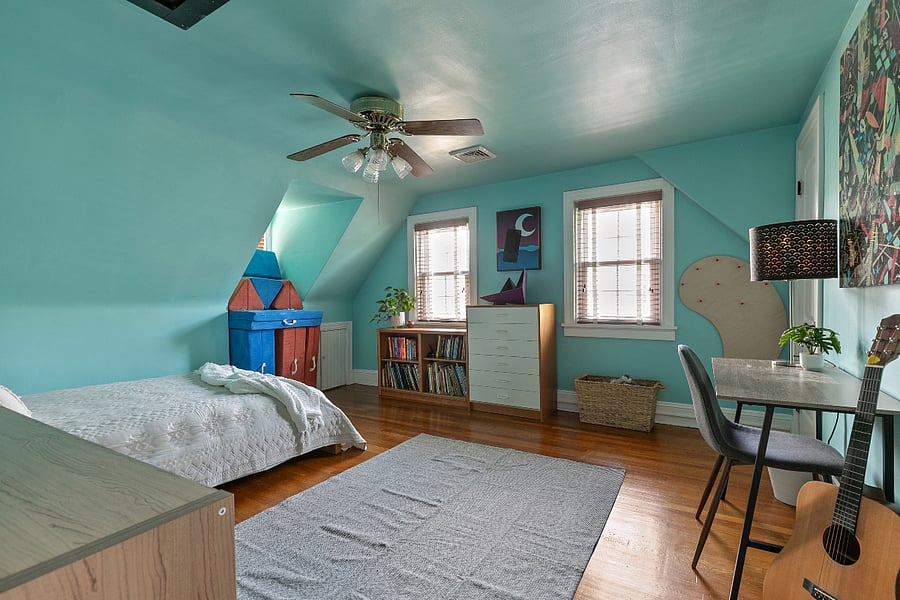 This bedroom/office features a queen bed and plenty of closet space with charming dormer windows.