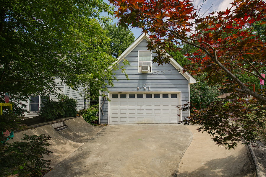 Featuring cafe lighting, a fire pit, gas grill, hand built play fort, and small scale concrete skate ramp, you wont find a backyard like this anywhere else. Garage building is the owner's studio and will not be accessible to renters.