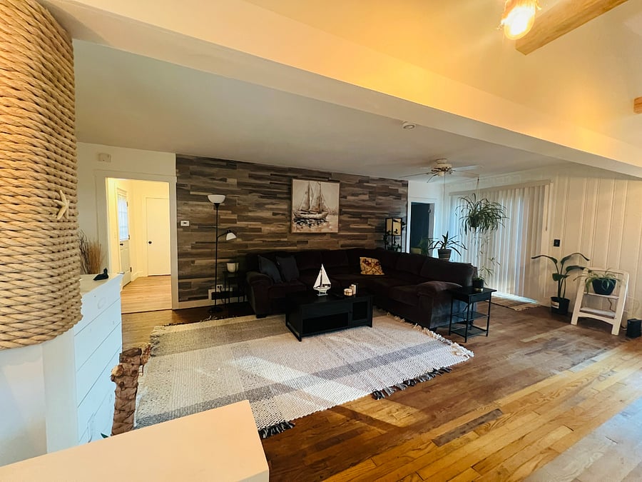 Spacious living room. Wrap around couch, super cozy. End tables with charging ports and outlets.